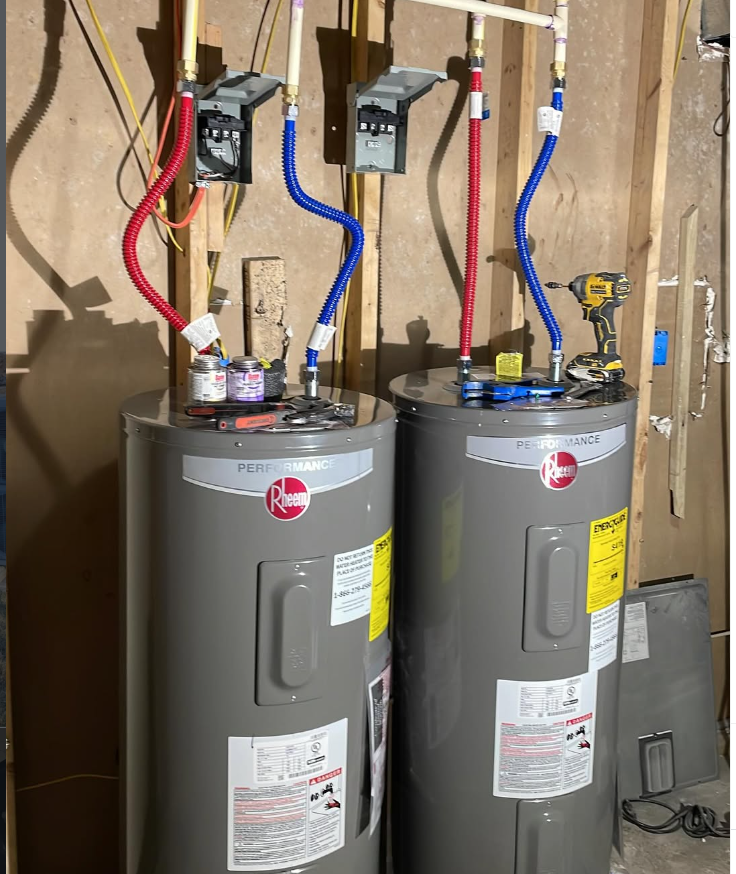 Two new Rheem Performance water heaters installed side by side with clean copper and PEX plumbing
